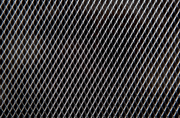 Metal grid on black background