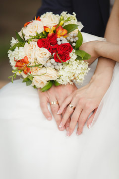 Hands of Bride and groom showing their wedding rings 