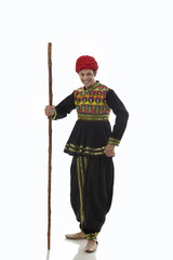 Portrait of a male dandiya dancer with a stick 