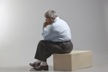Obese old man thinking