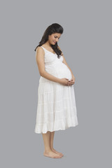 Pregnant woman holding her stomach