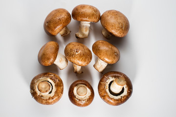 A pile of brown champignon mushrooms isolated on a white background