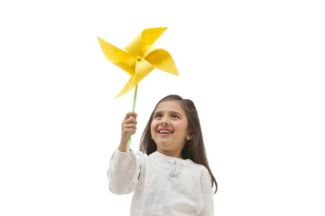 Young girl holding a toy windmill 