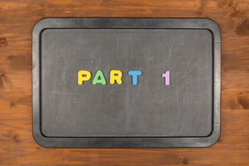part 1 title of colorful foam letters on chalkboard