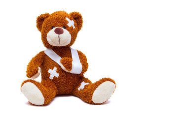 Injured teddy bear on white background