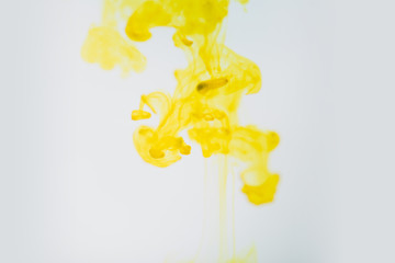 Yellow ink in water, artistic shot, abstract background