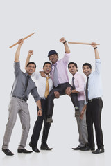 Executives cheering during cricket match 