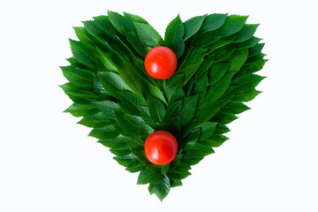 Tomatoes on the background of the heart of green leaves. The concept of love of nature and rational...
