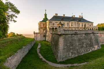 Fototapeta na wymiar Medieval Pidhirtsi Castle in sunset summer light, Pidhirtsi village, Lviv region, Ukraine