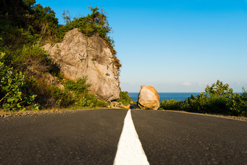 New asphalt road path blocked by land slide / rock fall.