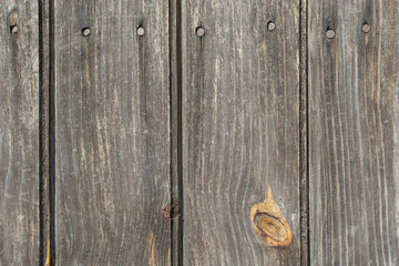 A background of wooden vertical white boards with a nail