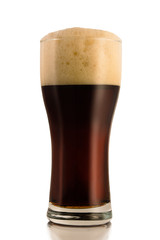 Dark beer in a glass, isolated on a white background