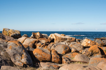 Blue sky, ocean and rock formations - coastline on a sunny winter's day at Bingi, near Moruya in NSW, Australia. Nature background.