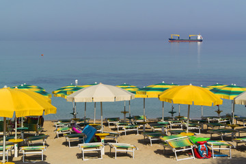 One day at the shore with ships on the horizon