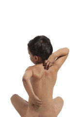 Naked boy scratching his back 