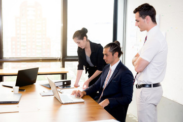American people business team having using laptop during a meeting and presents.