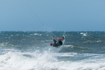 Kiteboarder enjoy surfing on a sunny day.