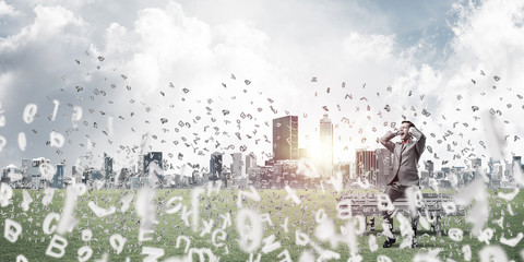 Young man on bench in summer park cant hear the sound