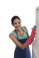 Close-up of young woman cleaning refrigerator