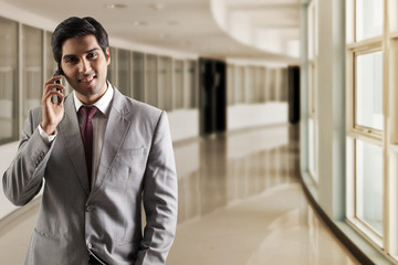 Portrait of young business man talking on phone 