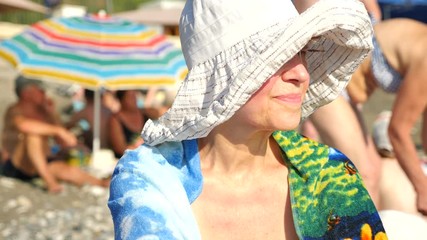 Active and Happy Senior Woman in broad-brimmed hat. Looking at Sea. 4k. Slow motion