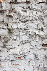 Broken old white brick wall