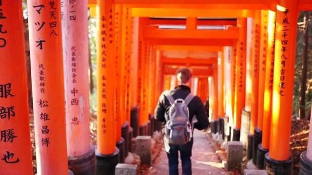 Man walks down stairs at Japanese Temple, slow motion