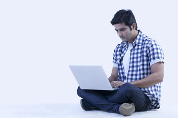 Serious university student using laptop 