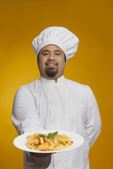 Portrait of chef with plate of pasta