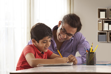 Father helping son with homework 