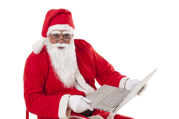 Portrait of Santa Claus holding laptop over white background 