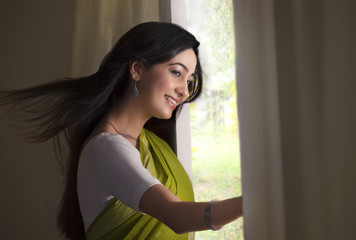 Woman looking out of a window 