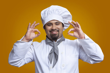 Portrait of chef giving ok hand gesture