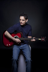 Obraz premium Young man playing the guitar