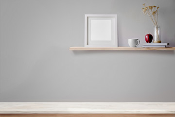 Obraz na płótnie Canvas Empty marble table top and wood shelf with blank white frame and coffee. Blank screen and copy space for products or graphic montage.