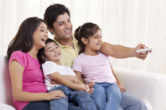 Cheerful family watching TV 