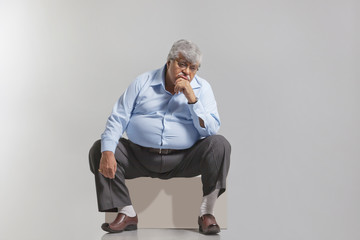 Obese old man feeling sad