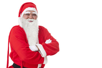 Fototapeta na wymiar Smiling Santa Claus with arms folded over white background 