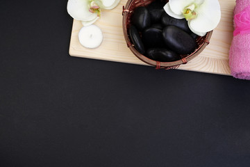 Spa and aromatherapy concept on black background. Zen stones, accessories used in aromatherapy. Flat lay. Top view.