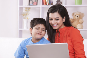 Mother and son looking at laptop