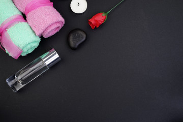 Spa and aromatherapy concept on black background. Zen stones, accessories used in aromatherapy. Flat lay. Top view.