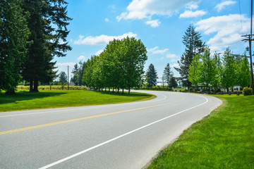 Fototapeta na wymiar Turn of asphalt road in rural area of Fraser Valley in British Columbia