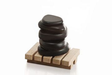 Stacked massage stones on wooden base 