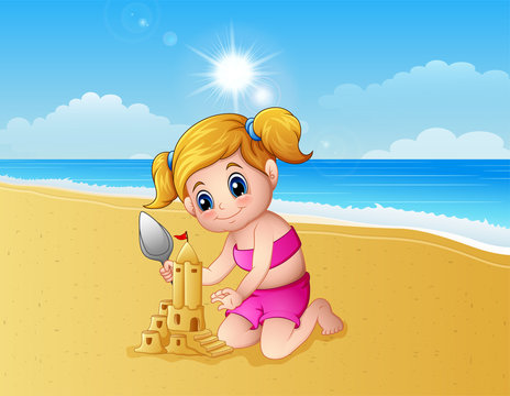 Girl making sand castle at the beach