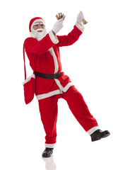 Full length of Santa Claus dancing with chocolate over white background 