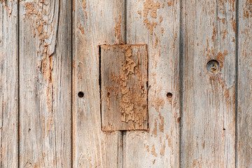 Wooden wall fragment with rectangular element in the middle, abstract texture