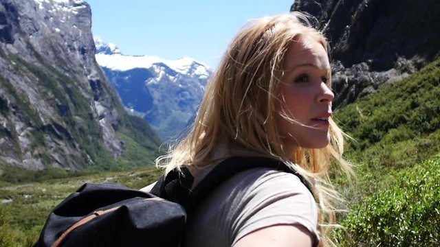Slow motion, young blonde woman backpacking New Zeland travel lifestyle