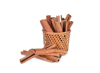 dried cinnamon in basket and on white background