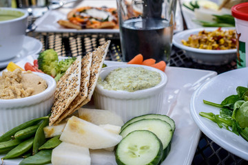 Fresh food on white plates at an outdoor restaurant in summer