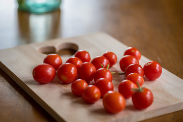 Heart healthy homegrown cherry tomatoes on a wood cutting board